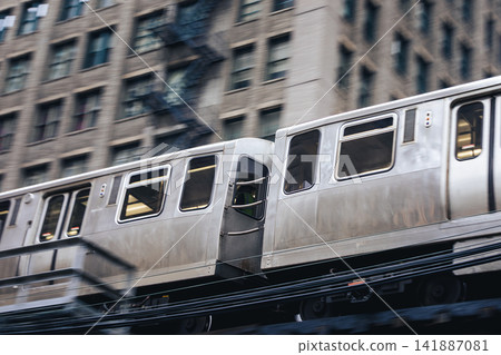 Train on elevated railway above street in downtown Chicago Train on elevated railway above street in downtown Chicago 141887081