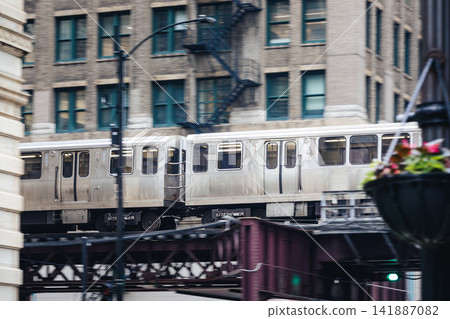 Train on elevated railway above street in downtown Chicago Train on elevated railway above street in downtown Chicago 141887082