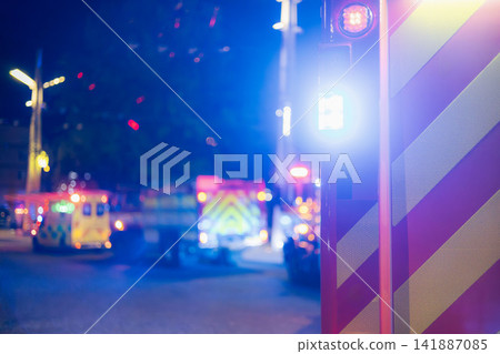 Flashing Fire Trucks and Ambulance on City Street at Night Flashing Fire Trucks and Ambulance on City Street at Night 141887085