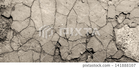 Plaster peeling due to age and a cracked concrete surface. Plaster peeling due to age and a cracked concrete surface. 141888107