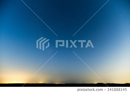 Milky Way Galaxy illuminating the night sky over a serene landscape 141888145