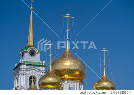 Golden domes and spires shine under a clear blue sky at the Cathedral of the Assumption in Tula Russia 141888904