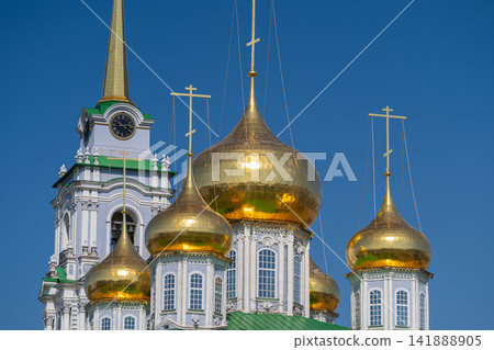 Golden domes gleam under a clear blue sky at the Cathedral of the Assumption in Tula Russia Golden domes gleam under a clear blue sky at the Cathedral of the Assumption in Tula Russia 141888905