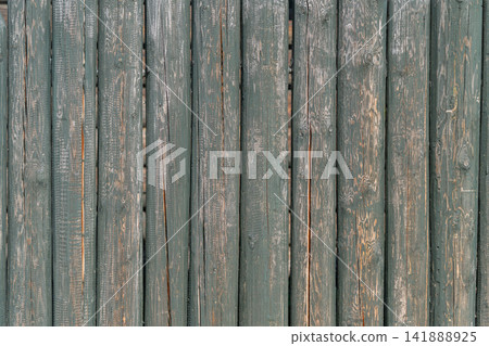 Weathered wooden fence panels exude rustic charm and character in a serene outdoor setting 141888925