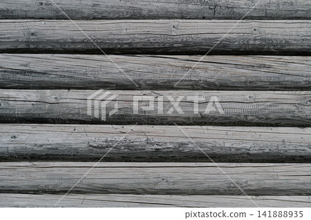 Natural beauty of rustic wooden logs stacked in a pattern showcasing age and texture in a serene outdoor setting Natural beauty of rustic wooden logs stacked in a pattern showcasing age and texture in a serene outdoor setting 141888935
