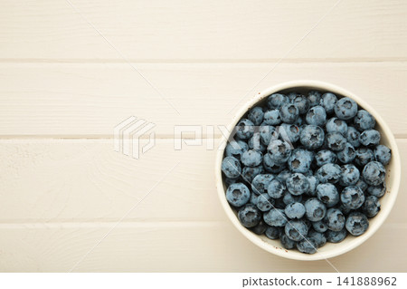 Blueberry in bowl on light wooden background. Space for text Blueberry in bowl on light wooden background. Space for text 141888962