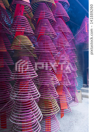 Incense spirals in a Taoist temple in Hong Kong, China Incense spirals in a Taoist temple in Hong Kong, China 141889260