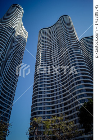 Vertical architectural perspective of modern glass skyscrapers in the metropolitan district Vertical architectural perspective of modern glass skyscrapers in the metropolitan district 141889345