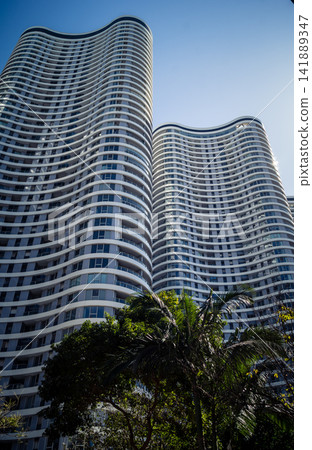 Vertical architectural perspective of modern glass skyscrapers in the metropolitan district Vertical architectural perspective of modern glass skyscrapers in the metropolitan district 141889347