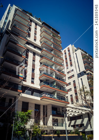 Vertical architectural perspective of modern glass skyscrapers in the metropolitan district 141889348