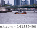 View of motorboats and passenger boats navigating the Chao Phraya River near Memorial Bridge 141889490