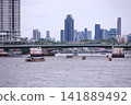 View of motorboats and passenger boats navigating the Chao Phraya River near Memorial Bridge 141889492