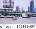 View of motorboats and passenger boats navigating the Chao Phraya River near Memorial Bridge 141889495