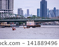 View of motorboats and passenger boats navigating the Chao Phraya River near Memorial Bridge 141889496