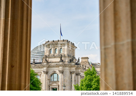 Reichstag Building framed by Brandenburg Gate columns Reichstag Building framed by Brandenburg Gate columns 141889554