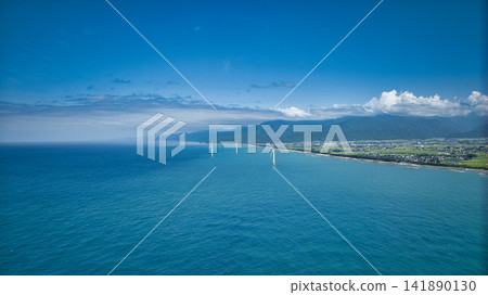 八月中旬，從富山縣下新川海岸可以看到海上風力渦輪機，遠處是笹川地區的山脈，以及更遠處的糸魚川地區。 141890130
