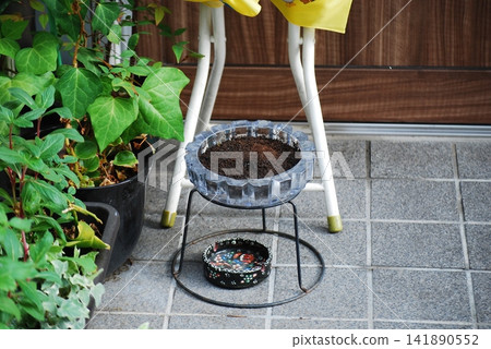 Ashtray placed in an outdoor smoking area Ashtray placed in an outdoor smoking area 141890552