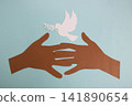 Brown paper hands protect a white paper dove of peace on a blue paper background 141890654