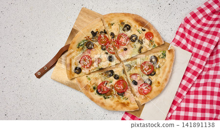 Appetizing pizza cut into pieces on a round white plate with tomatoes, olives, spices on a light background Appetizing pizza cut into pieces on a round white plate with tomatoes, olives, spices on a light background 141891138