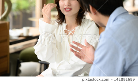 A young couple enjoying a conversation A young couple enjoying a conversation 141891699