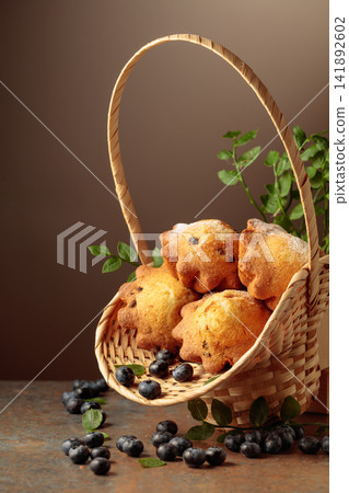 Freshly baked blueberry muffins in elegant basket. Freshly baked blueberry muffins in elegant basket. 141892602