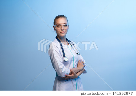 Female medical professional with safety glasses and stethoscope Female medical professional with safety glasses and stethoscope 141892977