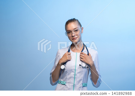 Female doctor wearing lab coat and safety glasses Female doctor wearing lab coat and safety glasses 141892988