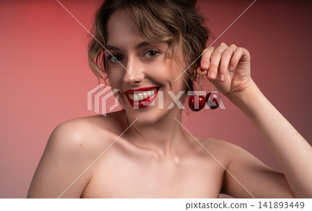 Woman smiling, holding fresh red cherries, cheerful portrait, beauty and healthy eating concept Woman smiling, holding fresh red cherries, cheerful portrait, beauty and healthy eating concept 141893449