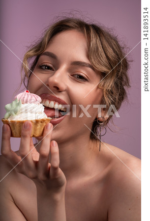 Young woman enjoying a sweet tart with cream and meringue, expressing delight and pleasure with a wide smile and open mouth Young woman enjoying a sweet tart with cream and meringue, expressing delight and pleasure with a wide smile and open mouth 141893514