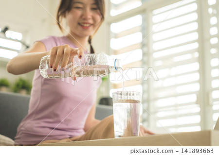 Young Asian Woman Working Online, Relaxing and Practicing Self Care During Daily Life at Home Young Asian Woman Working Online, Relaxing and Practicing Self Care During Daily Life at Home 141893663