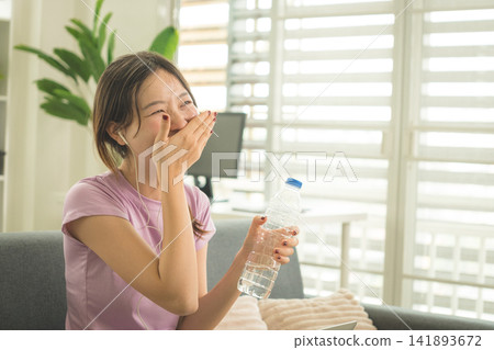 Young Asian Woman Working Online, Relaxing and Practicing Self Care During Daily Life at Home Young Asian Woman Working Online, Relaxing and Practicing Self Care During Daily Life at Home 141893672