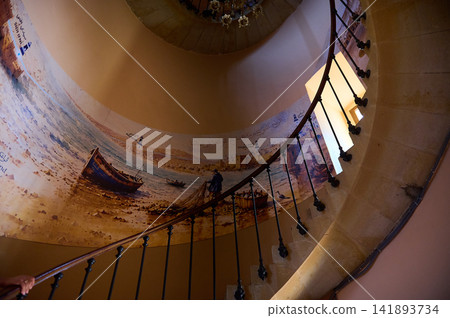 Spiral stone staircase with painted coastal mural inside a Tangier museum, Morocco Spiral stone staircase with painted coastal mural inside a Tangier museum, Morocco 141893734