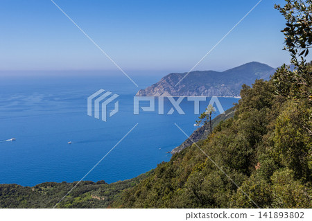 Cinque Terre within Liguria, Italy, including undeveloped mountains meeting calm sea Cinque Terre within Liguria, Italy, including undeveloped mountains meeting calm sea 141893802