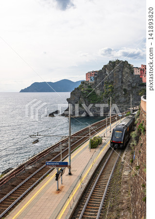 Passenger train in Manarola, Liguria, Italy from high perspective along the station Passenger train in Manarola, Liguria, Italy from high perspective along the station 141893820