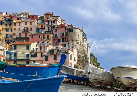 Fishing boats in Manarola, Cinque Terre, Italy from wide low-angle harbor perspective Fishing boats in Manarola, Cinque Terre, Italy from wide low-angle harbor perspective 141893824
