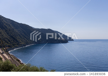 Coastal railway within Cinque Terre, Italy with rail line tracing the secluded coastline Coastal railway within Cinque Terre, Italy with rail line tracing the secluded coastline 141893836