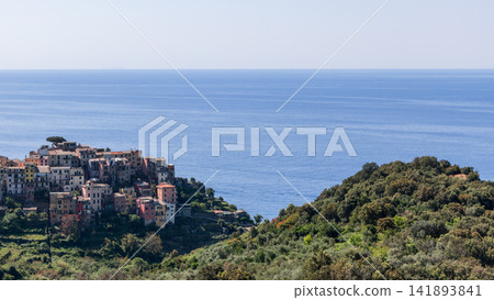 Corniglia within Liguria, Italy, including tight village cluster against open water 141893841