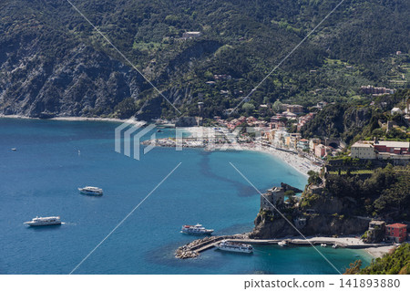 Monterosso al Mare in coastal Italy with four ferries surrounding the beach and pier 141893880