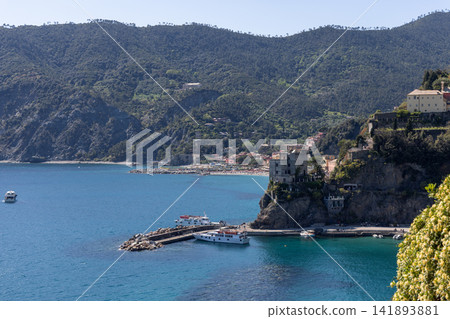 Ferry dock above Monterosso al Mare, Italy with ferries at the sheltered turquoise landing Ferry dock above Monterosso al Mare, Italy with ferries at the sheltered turquoise landing 141893881