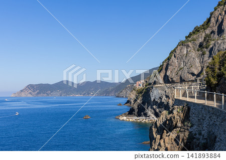Via dell Amore in Liguria, Cinque Terre, Italy with railing leading around a sheer rock wall Via dell Amore in Liguria, Cinque Terre, Italy with railing leading around a sheer rock wall 141893884