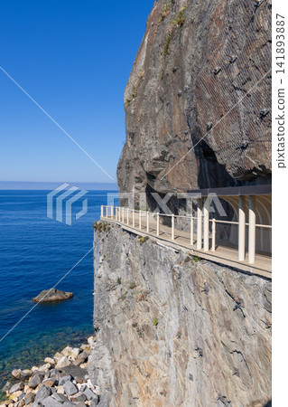 Via dell Amore along the Cinque Terre coast in Italy with massive rock face over pale colonnade Via dell Amore along the Cinque Terre coast in Italy with massive rock face over pale colonnade 141893887