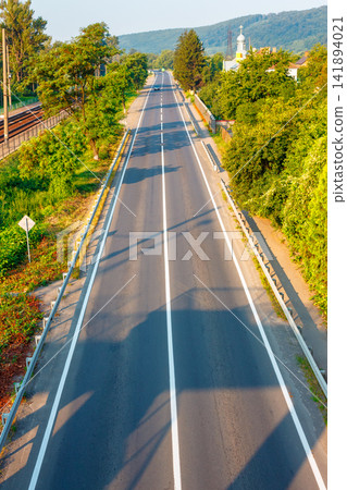 countryside road through carpathian mountains. beautiful summer landscape for ukraine travel background countryside road through carpathian mountains. beautiful summer landscape for ukraine travel background 141894021