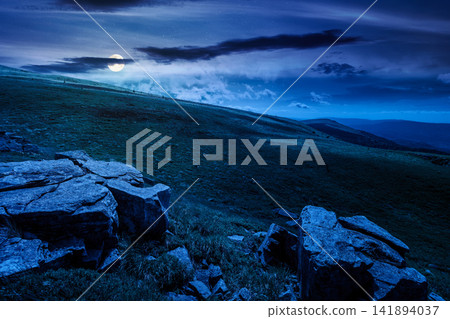 carpathian mountain landscape on summer night. mysterious background for outdoor adventure in the dark. transcarpathia green hill with rocks in foll moon light carpathian mountain landscape on summer night. mysterious background for outdoor adventure in the dark. transcarpathia green hill with rocks in foll moon light 141894037