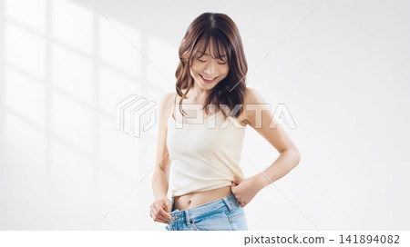 A woman who is happy to succeed in dieting A woman who is happy to succeed in dieting 141894082