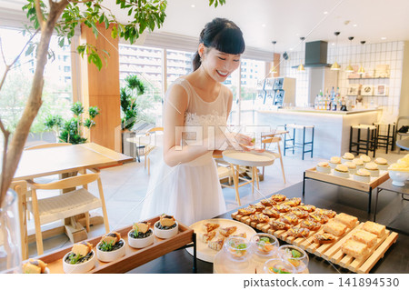 The bride enjoys the food at her restaurant wedding. The bride enjoys the food at her restaurant wedding. 141894530