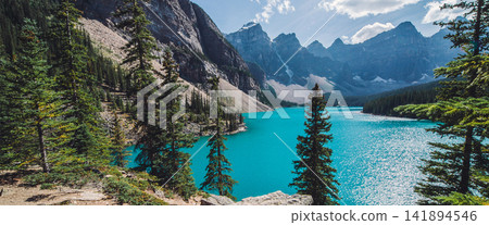 Turquoise Mountain Lake with Pine Forest and Rocky Peaks Turquoise Mountain Lake with Pine Forest and Rocky Peaks 141894546