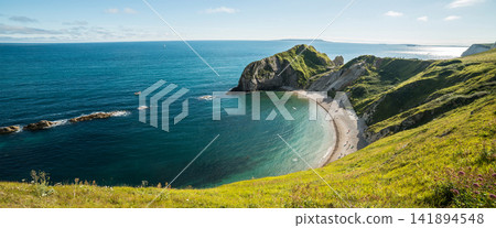 Coastal Cove with Turquoise Sea and Green Cliffs Panorama Coastal Cove with Turquoise Sea and Green Cliffs Panorama 141894548