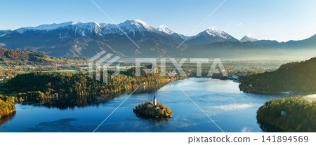 Lake Bled Island Church with Snowy Alps in Autumn Panorama Lake Bled Island Church with Snowy Alps in Autumn Panorama 141894569