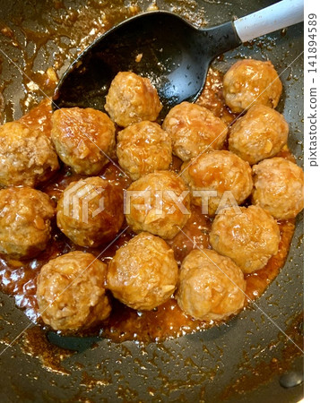 Homemade meatballs coated in a thick sauce in a frying pan. Homemade meatballs coated in a thick sauce in a frying pan. 141894589
