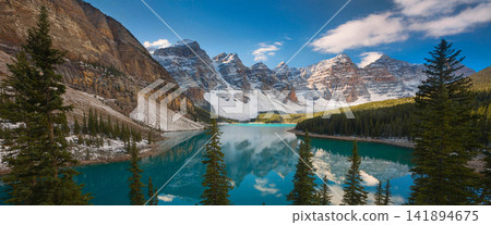 Turquoise Alpine Lake with Snowy Mountains and Pine Forest Turquoise Alpine Lake with Snowy Mountains and Pine Forest 141894675